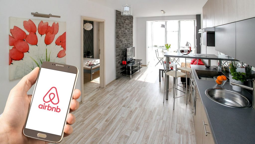 Picture of Airbnb mobile app and a vacation rental property suited for placement of an Airbnb welcome book.