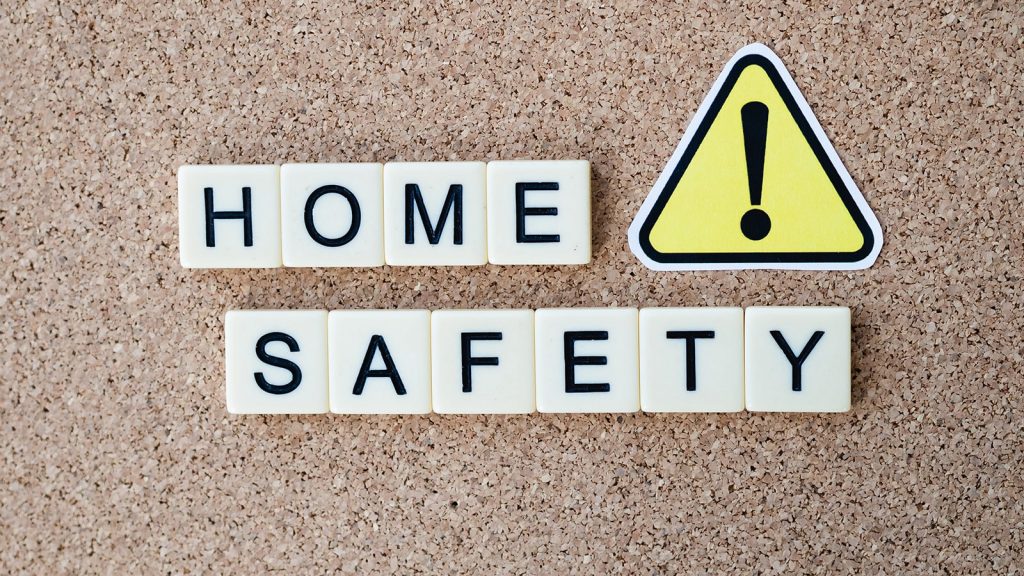 Graphic of the words "Home Safety" symbolizing the importance of including safety precautions in your Airbnb welcome book.