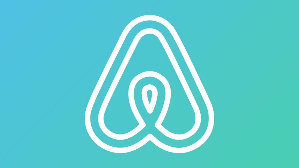 Portrait of the Airbnb logo on a colorful background.