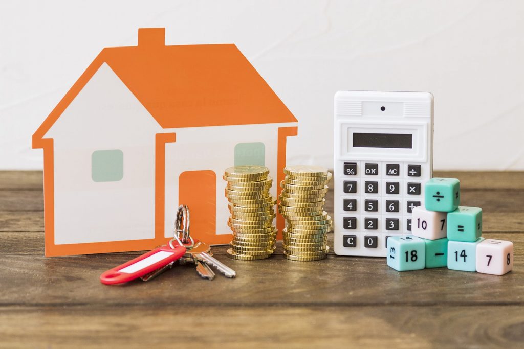 Portrait of keys to the rental property and tools for calculating rates for a direct booking short-term rental website.