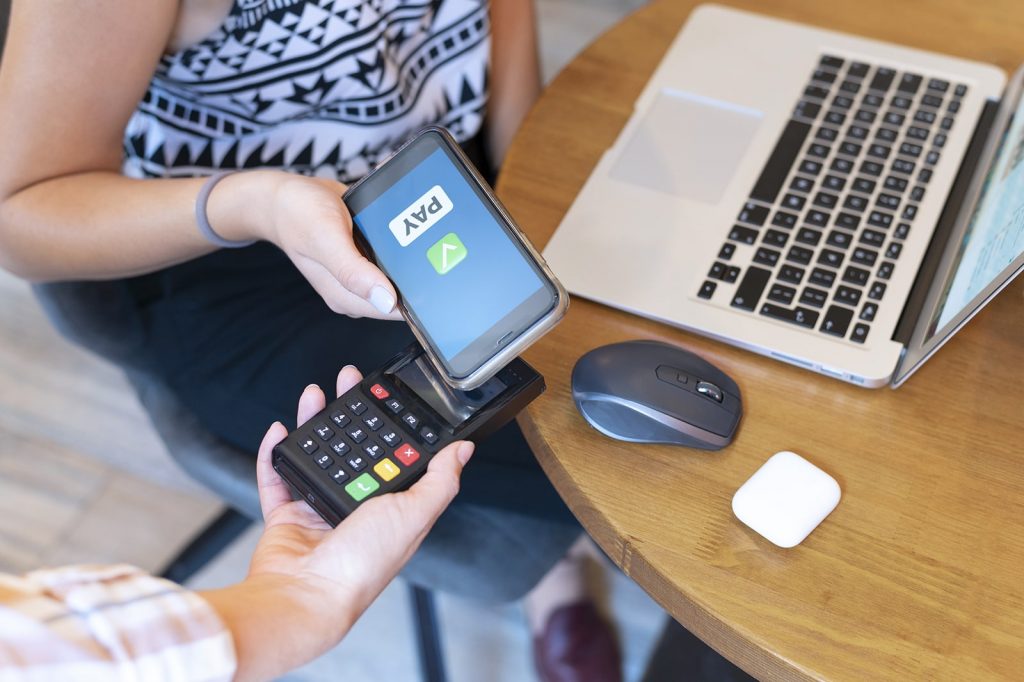 Picture of contactless payment technology that can be used by a business with a direct booking short-term rental website.