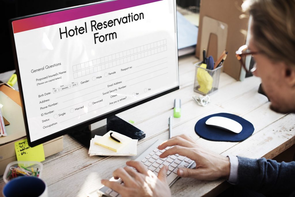 Visual of a person filling out the hotel reservation form online.