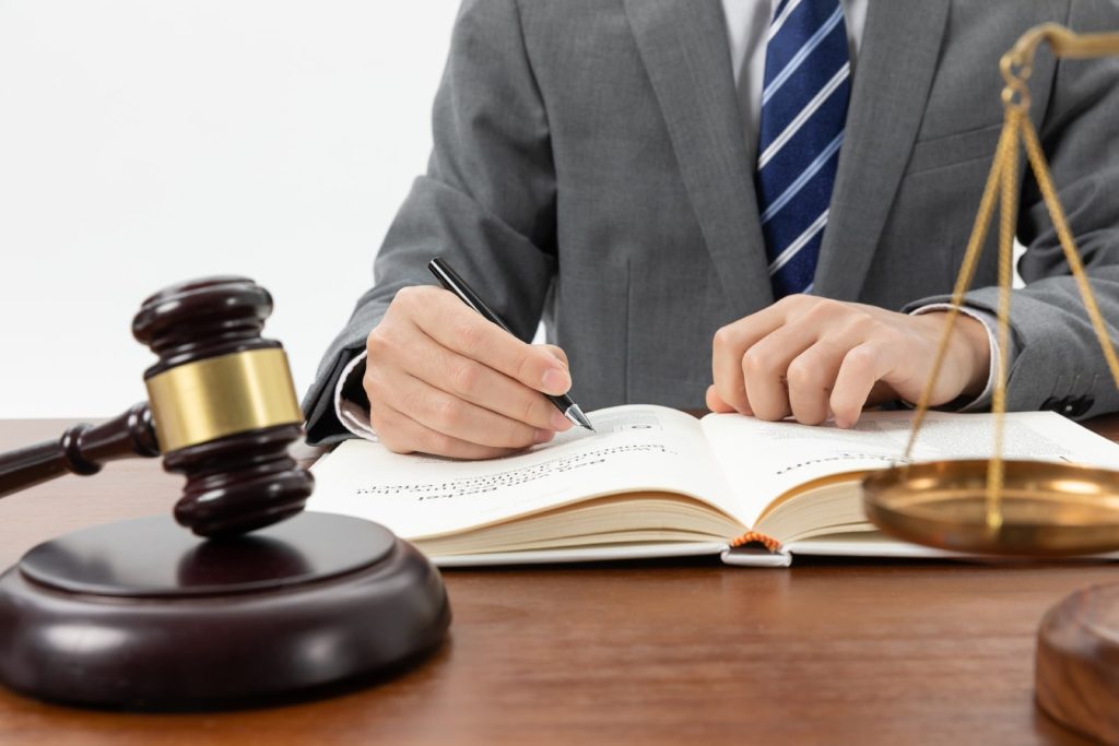 Photograph of an attorney marking legal details.