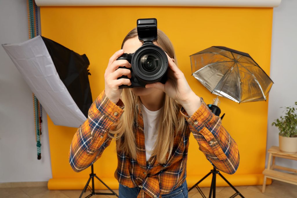 Photo of a photographer using equipment to take property photos and following tips for Airbnb photos.