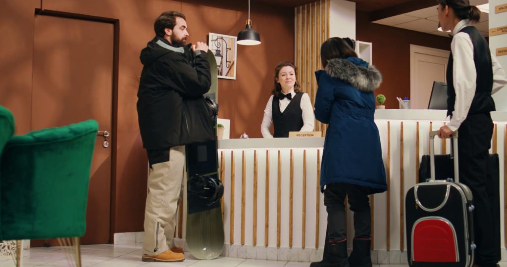 Figure of a hotel receptionist dealing with guests.